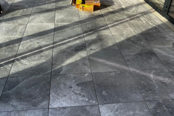 Slate-effect porcelain tiles on pedestal system for external terrace